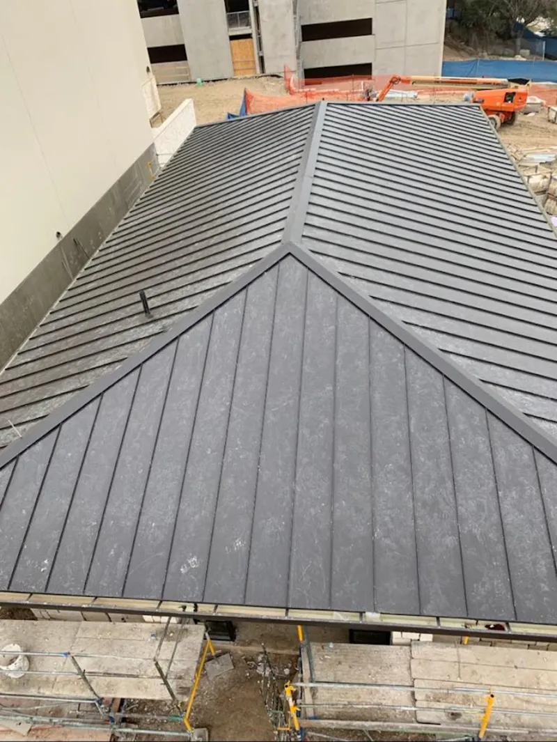 Commercial metal roof construction with crane equipment in Gulf Gate