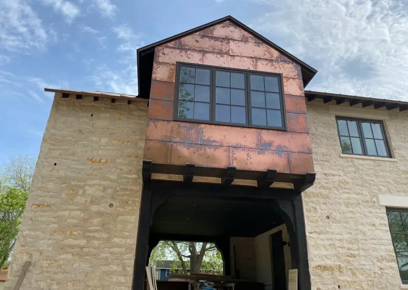 Copper metal panel facade on a stone building for Skylight Installation in Gulf Gate